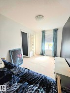 Room featuring light-toned carpeting and white walls - 