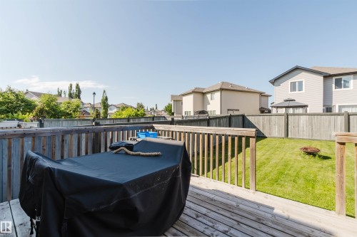 Wood-plank deck with a wood railing overlooking a fenced backyard - 17348 6 Avenue Nw, Edmonton, AB - Outdoor With Deck Patio Veranda With Exterior