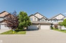 Contemporary two-story exterior with a two-car garage, stone accents, and a concrete driveway - 17348 6 Avenue Nw, Edmonton, AB  - Outdoor With Facade 