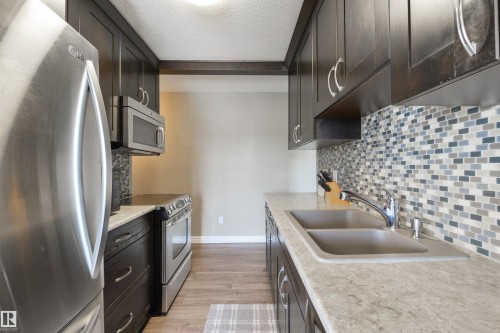 #401 11026 106 St Nw, Edmonton, AB - Indoor Photo Showing Kitchen With Stainless Steel Kitchen With Double Sink With Upgraded Kitchen