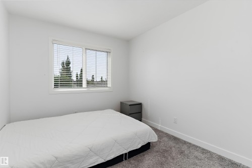 White walls and trim with light gray carpeting - 1439 Goodspeed Lane Nw, Edmonton, AB - Indoor Photo Showing Bedroom