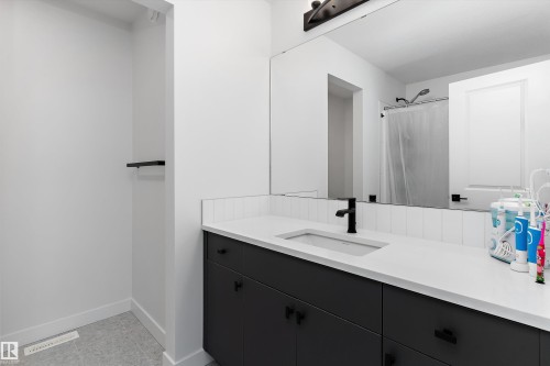 Bathroom vanity with a white countertop and integrated sink - 1439 Goodspeed Lane Nw, Edmonton, AB - Indoor Photo Showing Bathroom