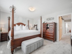 Carpeted room featuring light gray wall paint, a built-in light fixture, and a wooden barn door - 
