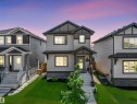 Two-story residence featuring light gray siding with dark gray trim accents and a contrasting dark gray roof - 283 Ameena Drive, Leduc, AB  - Outdoor With Facade 