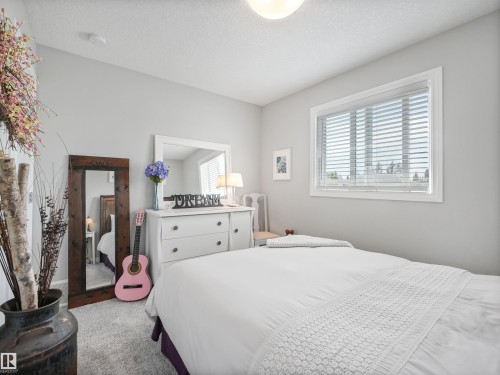 Light-colored walls complement the plush carpeting - 283 Ameena Drive, Leduc, AB - Indoor Photo Showing Bedroom