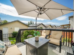 Outdoor deck featuring a dark railing system and a textured gray floor - 