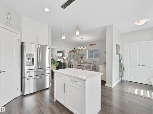 Kitchen featuring a central island with white cabinetry and a solid surface countertop - 283 Ameena Drive, Leduc, AB - Indoor Photo Showing Kitchen