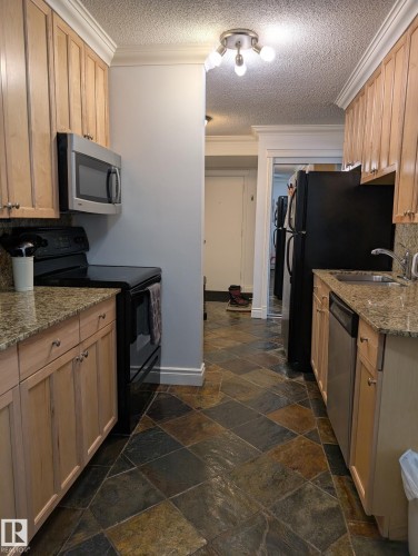 #101 10745 83 Av Nw, Edmonton, AB - Indoor Photo Showing Kitchen With Double Sink