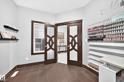 Room featuring brown tile flooring and light gray walls - 16244 138 Street Nw, Edmonton, AB - Indoor Photo Showing Other Room