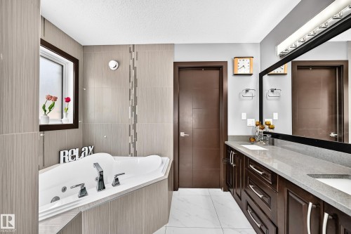 Soaking tub with deck-mounted chrome fixtures - 16244 138 Street Nw, Edmonton, AB - Indoor Photo Showing Bathroom