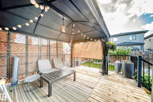 Wood-finish deck featuring a covered gazebo with string lighting and privacy screens - 16244 138 Street Nw, Edmonton, AB - Outdoor With Deck Patio Veranda With Exterior