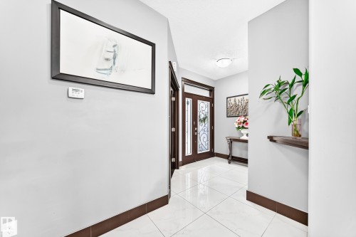Entryway featuring white square tile flooring and light gray walls with dark brown baseboards - 16244 138 Street Nw, Edmonton, AB - Indoor Photo Showing Other Room