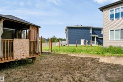 Elevated wood-deck gazebo featuring a black metal roof and privacy curtains - 