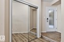 Mirrored sliding closet doors and wood-finish flooring - #100 4835 104A St Nw, Edmonton, AB 