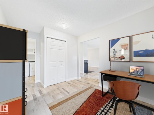 Light wood-finish flooring extending throughout the space - 152 Surrey Gardens, Edmonton, AB - Indoor Photo Showing Other Room