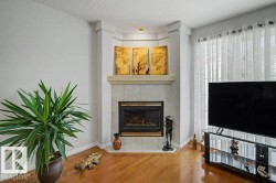 Corner fireplace featuring a tile surround and mantel - 