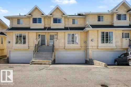 Multi-level townhouse exterior featuring stucco finish and gabled roofs - #39 2419 133 Av Nw, Edmonton, AB - Outdoor With Facade