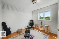 Bright room featuring wood-finish flooring and a single window with blinds - 