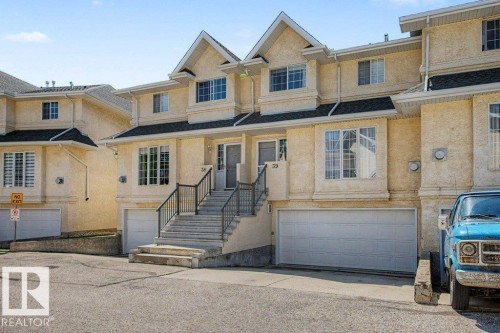 Multi-level townhome featuring a stucco exterior and gabled roofline - #39 2419 133 Av Nw, Edmonton, AB - Outdoor With Facade