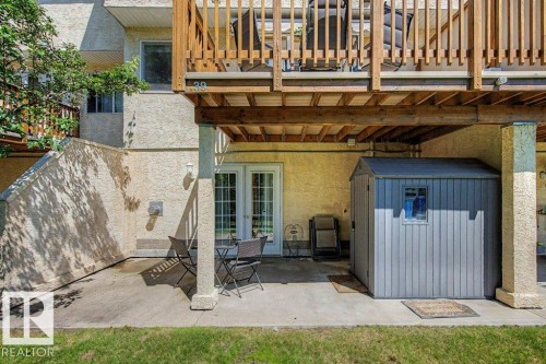 Ground-level patio with direct outdoor access via double French doors - #39 2419 133 Av Nw, Edmonton, AB - Outdoor With Exterior