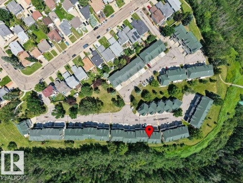 Aerial view of a residential community featuring townhomes with green roofs, surrounded by mature trees - #39 2419 133 Av Nw, Edmonton, AB - Other