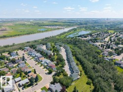 Aerial perspective showcasing a residential community situated alongside a river - 