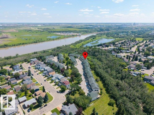 Aerial perspective of a multi-unit residential development bordering a wooded area - #39 2419 133 Av Nw, Edmonton, AB - Outdoor With View