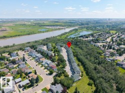 Aerial perspective of a multi-unit residential development bordering a wooded area - 