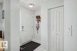 Entryway featuring white six-panel door with smart lock, flush-mount ceiling fixture, and bi-fold closet doors - 