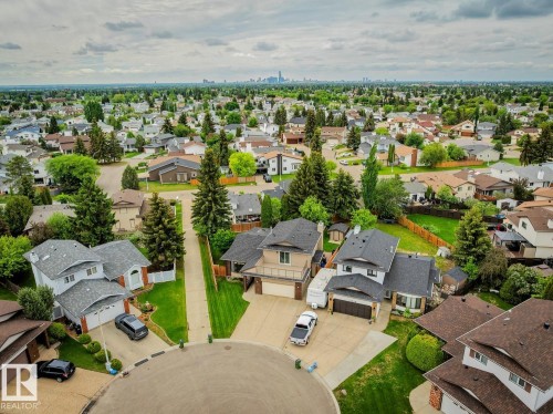 Residential neighborhood with mature trees and a distant cityscape on the horizon - 15804 80 Street Nw, Edmonton, AB - Outdoor With View