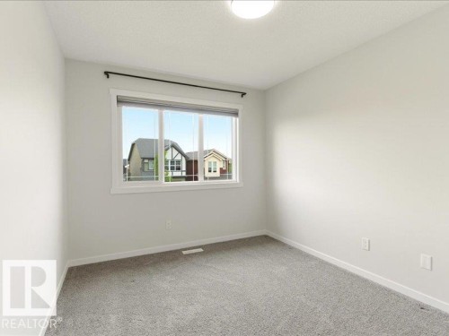 Neutral-toned walls complement the gray carpeting - 17487 77 Street, Edmonton, AB - Indoor Photo Showing Other Room