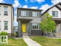 Modern two-story residence with a vibrant yellow front door and covered entry porch - 17487 77 Street, Edmonton, AB  - Outdoor With Facade 