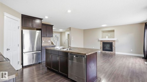 17211 78 Street Nw, Edmonton, AB - Indoor Photo Showing Kitchen With Fireplace With Double Sink