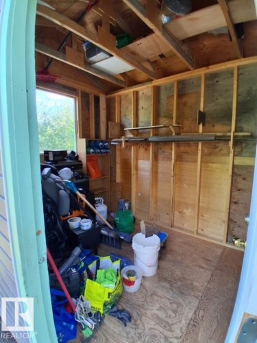 Utility structure featuring exposed wood framing, plywood walls, and a single window - 204 Sandy Beach Way, Rural Two Hills County, AB - Indoor