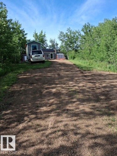 Gravel driveway leading to a residence with light gray siding and a dark roof - 204 Sandy Beach Way, Rural Two Hills County, AB - Outdoor