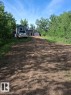 Gravel driveway leading to a residence with light gray siding and a dark roof - 204 Sandy Beach Way, Rural Two Hills County, AB  - Outdoor 