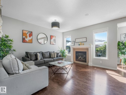 908 Goshawk Point(E) Nw, Edmonton, AB - Indoor Photo Showing Living Room With Fireplace