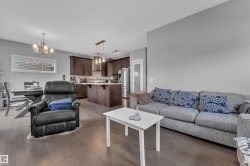 Open-concept living area featuring rich wood-finish flooring - 