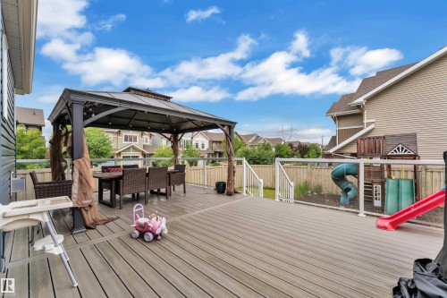 Expansive composite deck featuring a dedicated gazebo area with string lighting and a fenced yard - 1942 Chapman Road Sw, Edmonton, AB - Outdoor With Deck Patio Veranda With Exterior