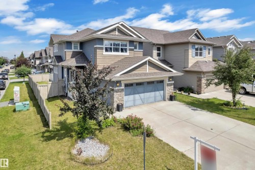 Two-story residence featuring a blue and tan exterior with stone accents - 1942 Chapman Road Sw, Edmonton, AB - Outdoor With Facade