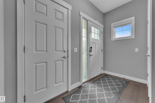 Entryway featuring dark wood-finish flooring, light grey walls, and white trim - 1942 Chapman Road Sw, Edmonton, AB - Indoor Photo Showing Other Room