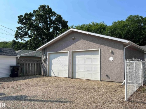 Detached two-car garage with stucco exterior and panel-style doors - 9723 65 Avenue Nw, Edmonton, AB - Outdoor With Exterior