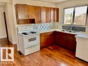 Kitchen featuring wood-finish flooring and ample cabinetry - 5206 51Ave, Willingdon, AB  - Indoor Photo Showing Kitchen With Double Sink 
