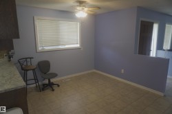 Light-toned tile flooring, painted walls, and a ceiling fan with integrated lighting - 