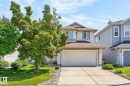 Two-story residence featuring light-colored siding and a double-wide concrete driveway - 3211 Mcphadden Place Sw, Edmonton, AB  - Outdoor 