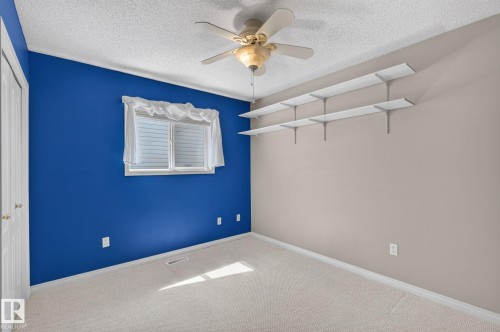 Light-colored carpeting with textured ceiling - 3211 Mcphadden Place Sw, Edmonton, AB - Indoor Photo Showing Other Room