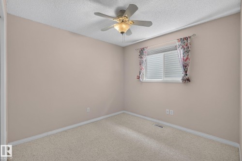 Neutral-toned room featuring a ceiling fan with integrated lighting - 3211 Mcphadden Place Sw, Edmonton, AB - Indoor Photo Showing Other Room