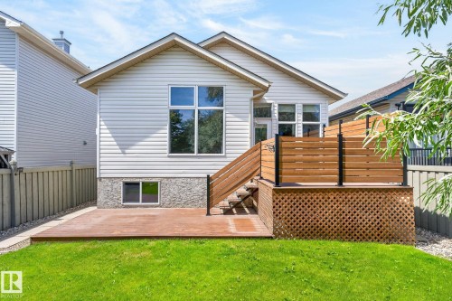 Rear exterior featuring a multi-level wood deck, privacy screen, and a green lawn - 3211 Mcphadden Place Sw, Edmonton, AB - Outdoor With Deck Patio Veranda With Exterior