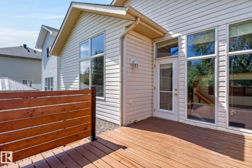 Outdoor deck space featuring wood decking and a horizontal plank privacy screen - 3211 Mcphadden Place Sw, Edmonton, AB - Outdoor With Deck Patio Veranda With Exterior