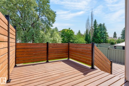 Wood-finish deck with horizontal slat fencing and black posts - 3211 Mcphadden Place Sw, Edmonton, AB - Outdoor With Deck Patio Veranda